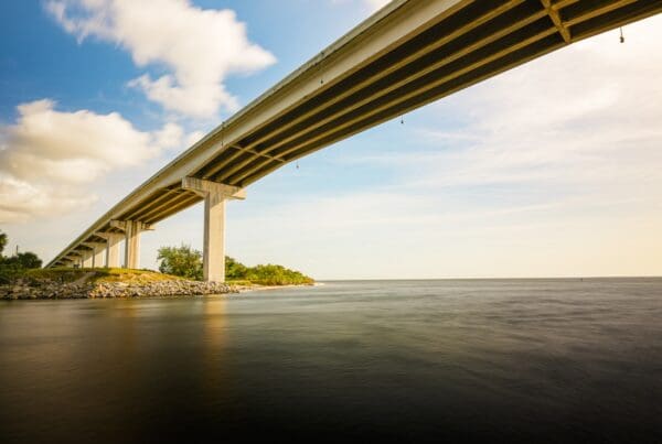 Port Saint Joe, FL - Long Bridge Spanning a Calm Bay Under a Blue Sky