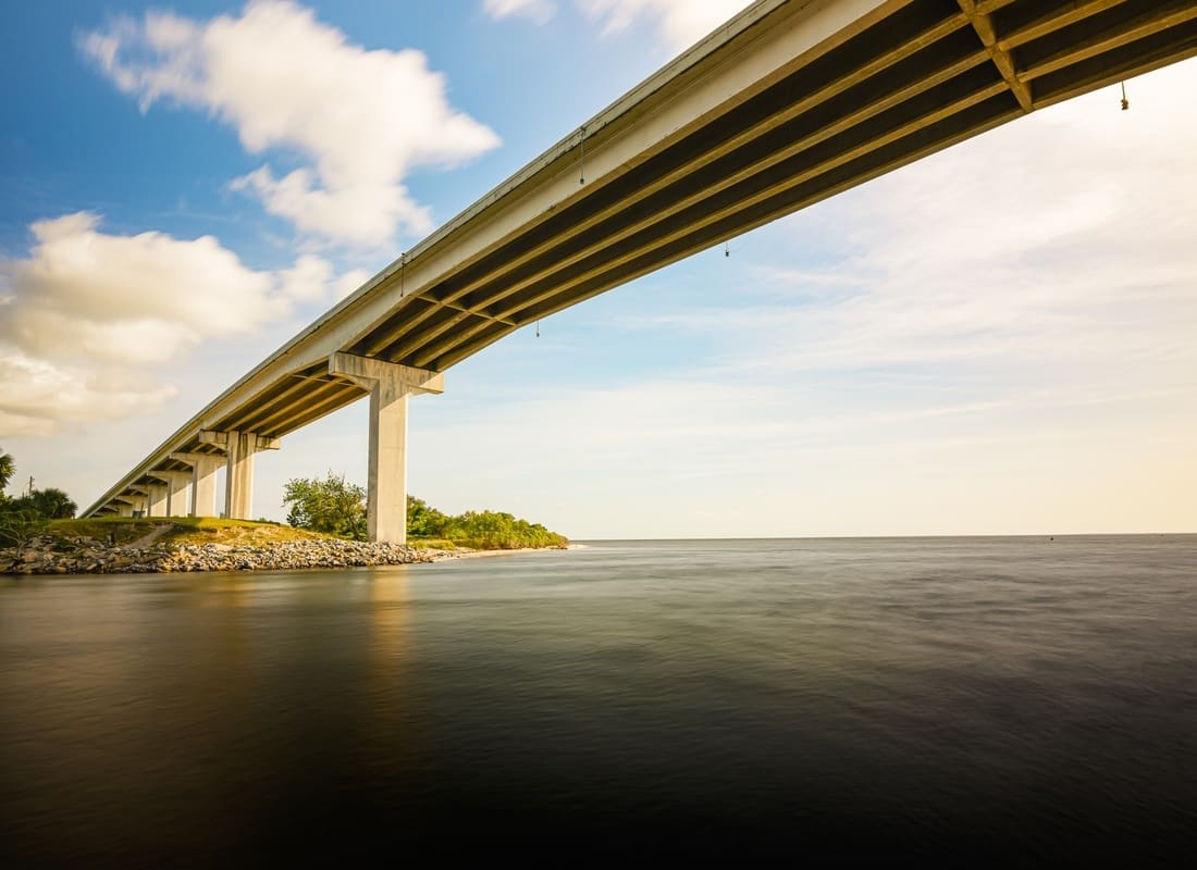 Port Saint Joe, FL - Long Bridge Spanning a Calm Bay Under a Blue Sky